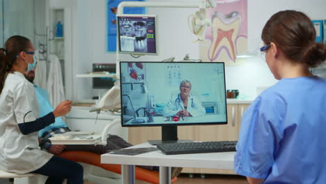 assistent having video call with expert stomatologic doctor