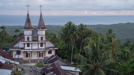 a church overlooking the ocean in a tropical village