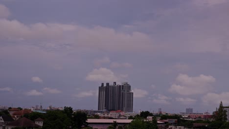 timelapse of clouds drifting above bangkok high-rise and rooftops