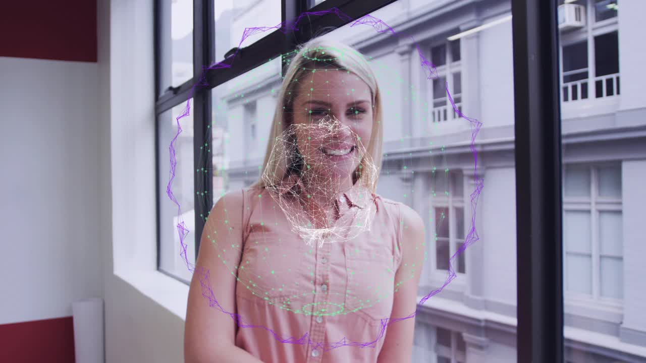 Woman responding to offscreen prompt leaning and smiling while tech network graphic projecting