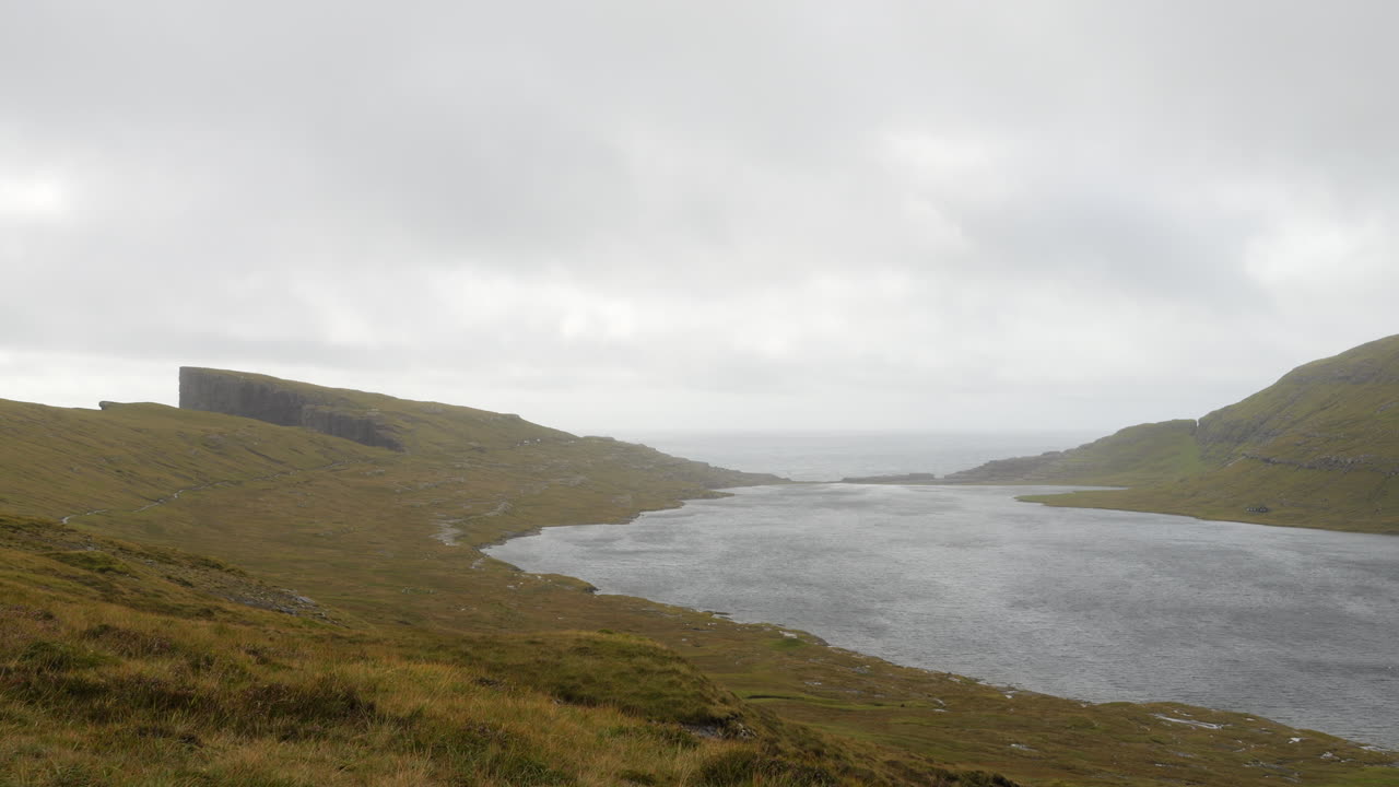 Panorama of Lake Sorvagsvatn on cloudy day, ocean in background, Faroe Islands. Static