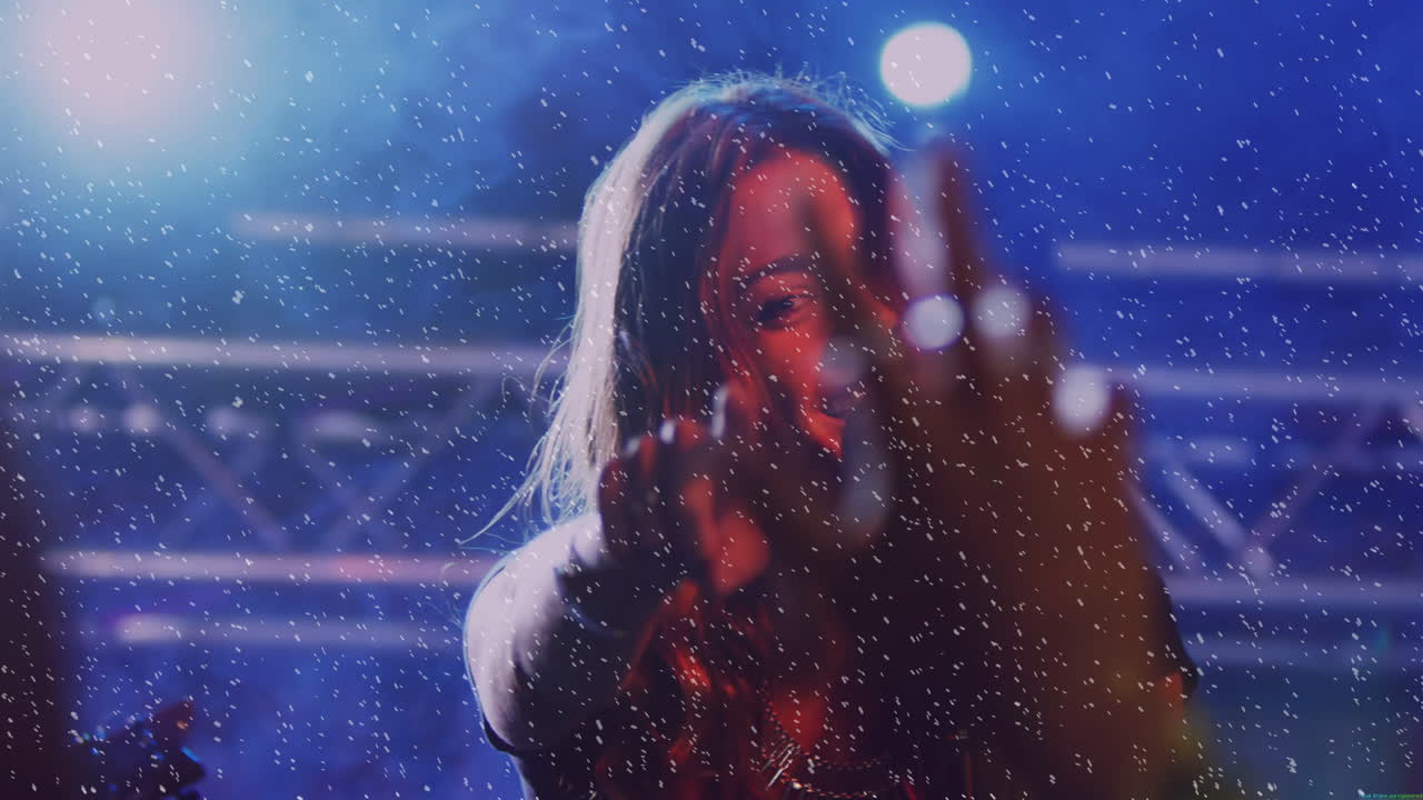 Female singer performing on music stage, using microphone amidst animated confetti and spotlights