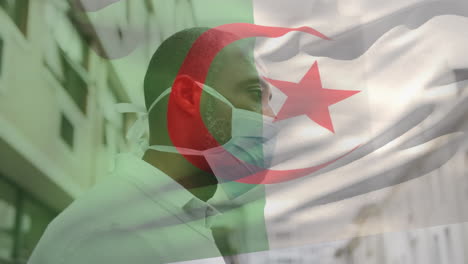 animation of flag of algeria waving over man wearing face mask during covid 19 pandemic