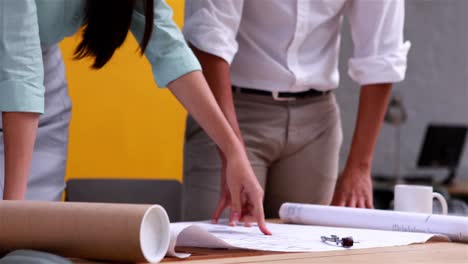 team of architects studying blueprints