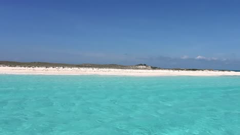 pov sailing toward white sandbank on caribbean turquoise sea water, los roques