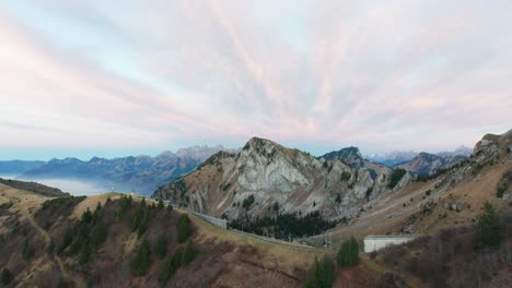 Beautiful-aerial-of-train-tracks-running-over-a-high-mountain-summit