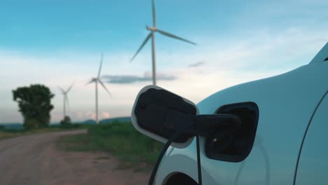 progressive combination of ev car, charging station and wind turbine.