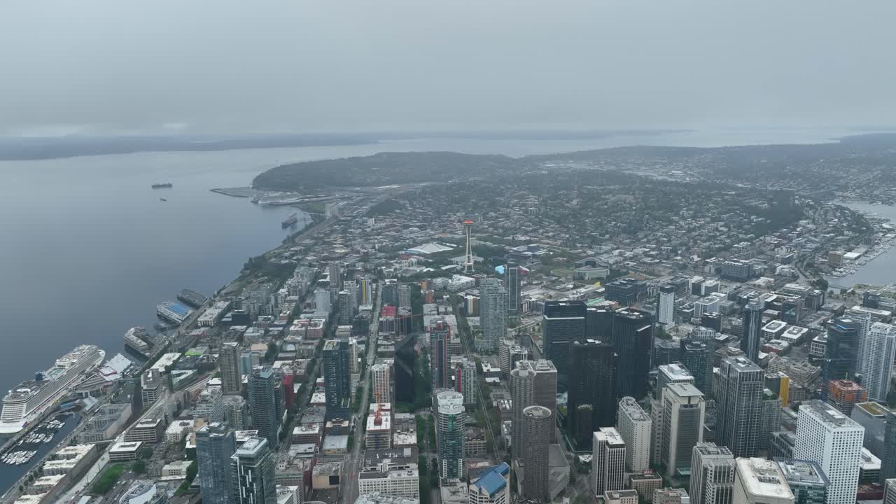 Aerial view of Seattle's downtown area surrounded by low lying clouds