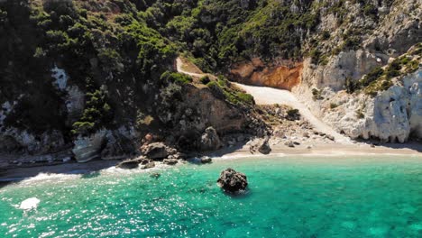 glistening waters by the beach in agia eleni, kefalonia, greece - aerial shot