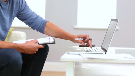 primer plano de un hombre casual trabajando con un cuaderno