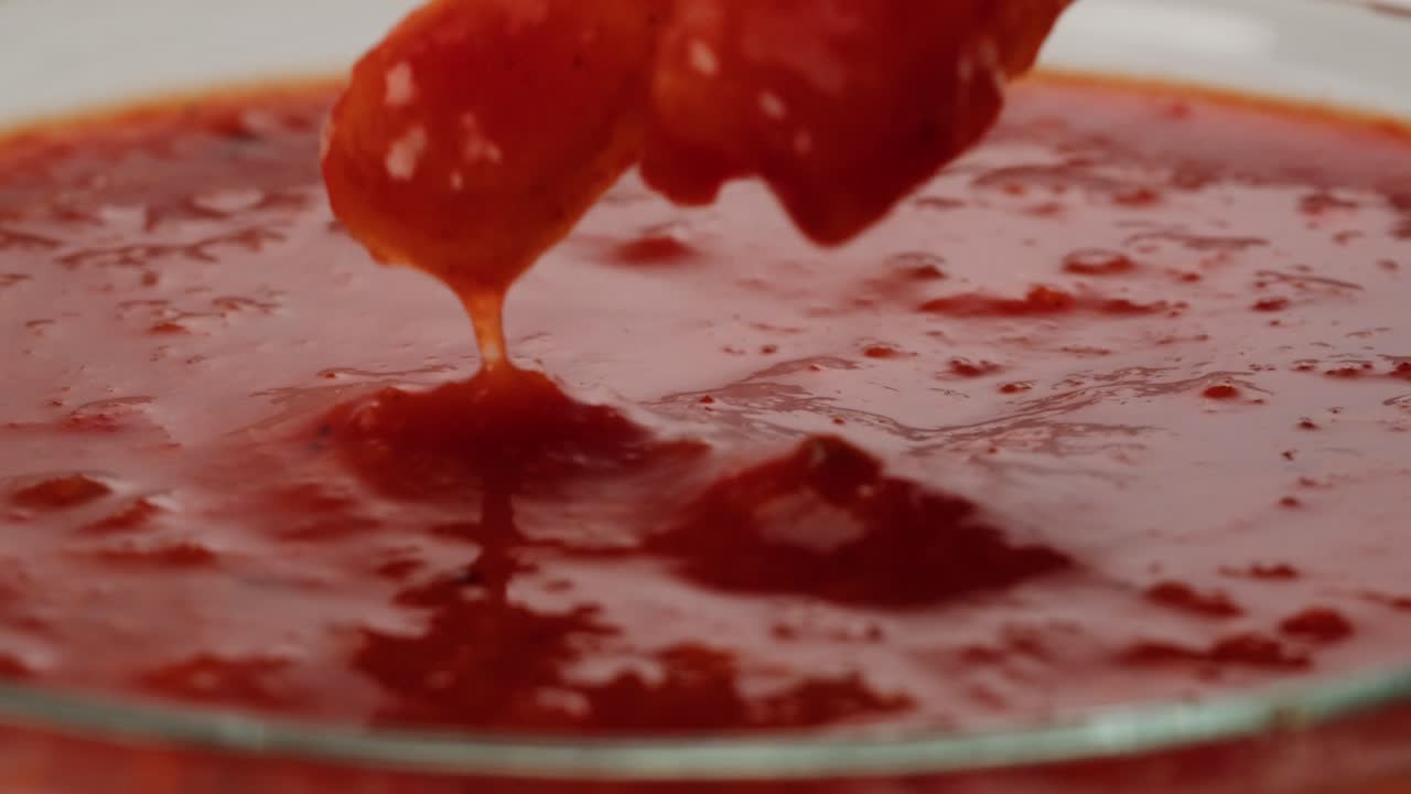 French Fries Dipping in Tomato Sauce