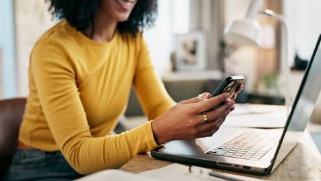 woman using laptop and mobile phone at home office