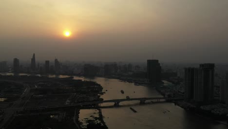 drone shot of saigon river smoggy sunset typical of a day with an extreme air pollution reading in southeast asia