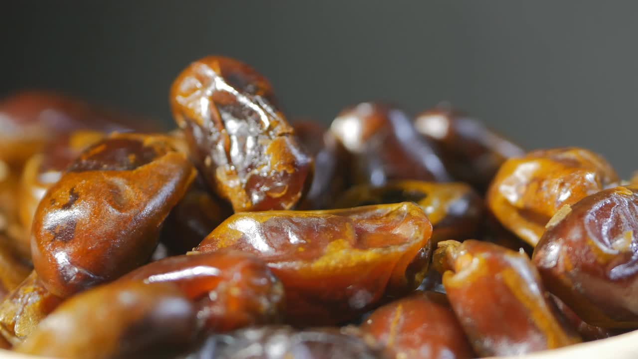 super close-up of arb dates rotating. Only dates and gray background. Healthy food concept. 4k