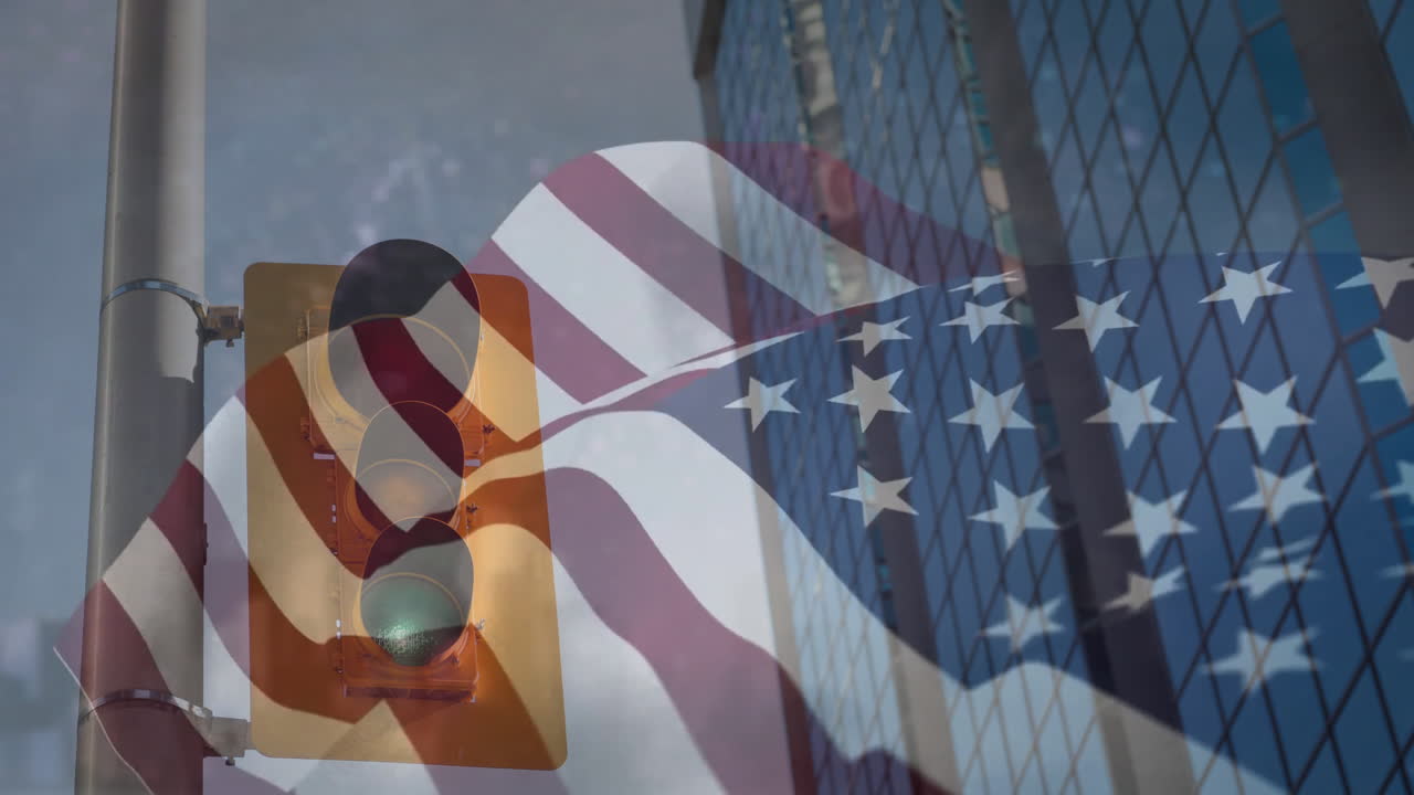 American flag animation over traffic light and modern glass building