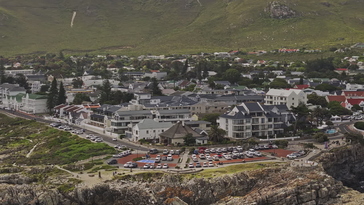 Hermanus South Africa Aerial v9 zoomed flyover around Gearing's Point capturing rocky shoreline, cliffside park, charming townscape and mountain views - Shot with Mavic 3 Pro Cine - Jan 8th 2024