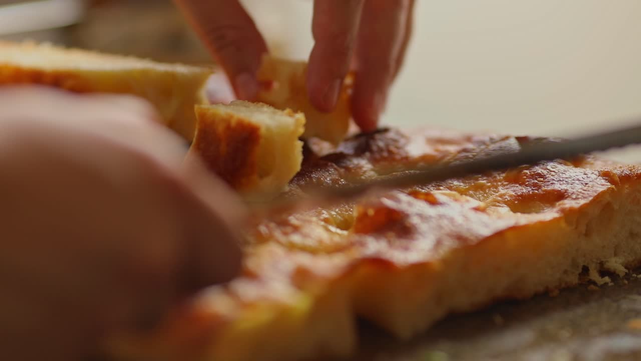 Cutting bread made from cassava flour into bite-size cubes - organic ingredients from the Amazon rainforest