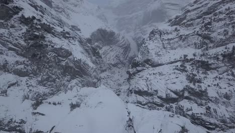 aerial-view-of-a-mountain-wall-in-winter-in-Grindelwald,-Switzerland