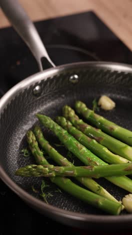 cooking asparagus in a pan