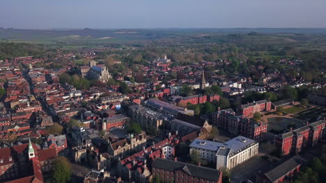 Aerial-shot-orbiting-over-Winchester-UK-towards-Winchester-Cathedral-morning-day-4K