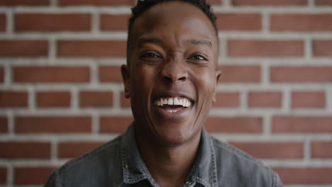 close up portrait young african american man student laughing happy enjoying lifestyle success independent black male slow motion