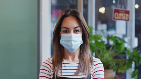 Portrait-of-Female-hairdresser-wearing-face-mask-at-hair-salon