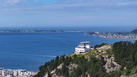 aerial view of viewpoint building above alesund city and fjords of norway, drone shot