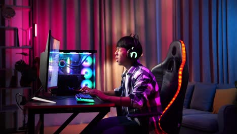 asian teen boy gamer lose while playing video game on computer