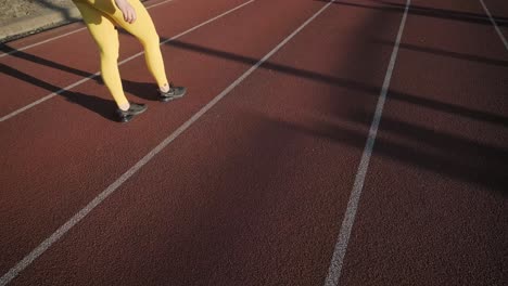 woman walking on a running track