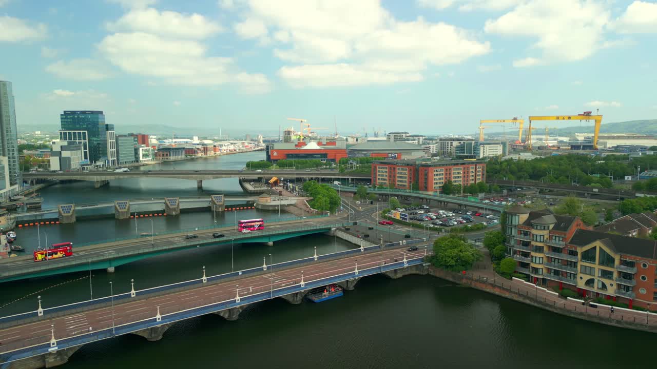 Aerial video of Belfast City Centre in Northern Ireland, UK on a bright sunny day. The Harland and Woolf cranes are visible in the background. Filmed in 4K, 60FPS and in Rec709 Color.