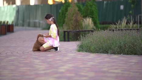 a-little-girl-playing-with-her-maltipoo-dog-a-maltese-poodle-breed