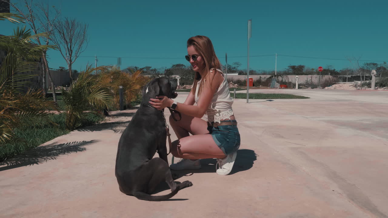 Woman and her dog enjoying a sunny day outdoors