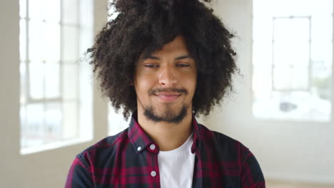 a young black confident male with an afro taking