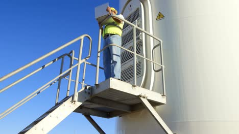 male engineer using laptop in the wind farm 4k