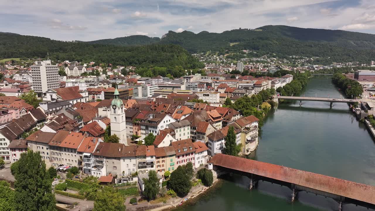 aerial - historic covered bridge crosses river aare in central olten solothurn switzerland