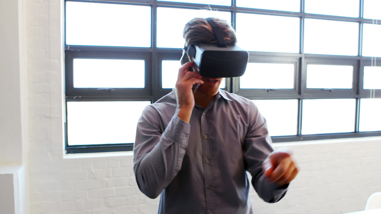 Businessman talking on mobile phone while using virtual glasses
