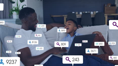 social media analytics animation over father and son using laptop on couch