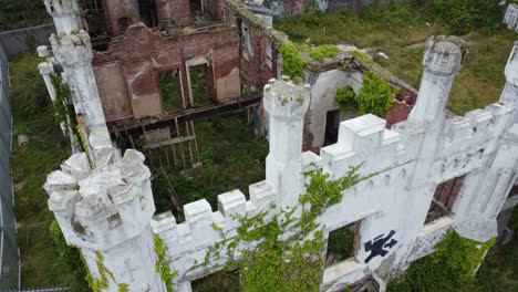 Soldiers point house aerial view over abandoned ruins of white castle mansion Holyhead country park