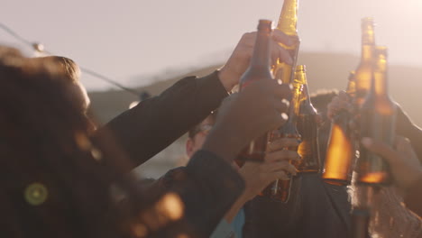 happy-group-of-friends-celebrating-rooftop-party-making-toast-drinking-beer-enjoying-reunion-celebration-on-weekend-social-gathering-at-sunset