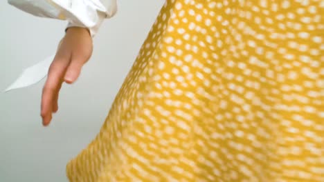 girl spinning her cute, yellow dress