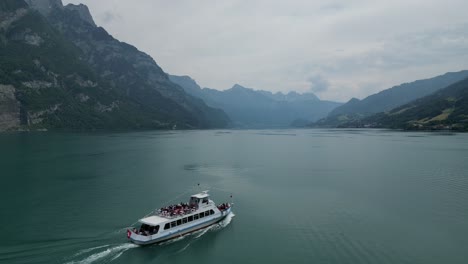 Leisurely-cruise-boat-taking-tourists-on-ride-in-scenic-Switzerland-lake