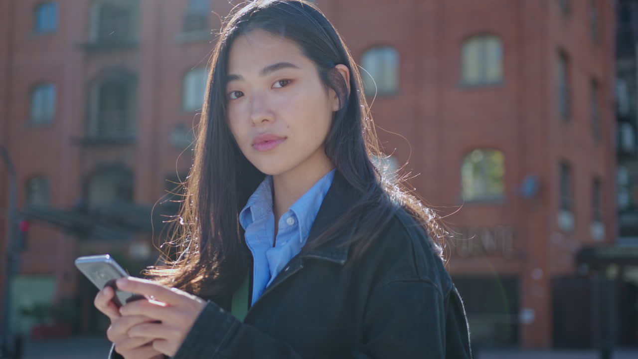 Portrait of Beautiful Asian Woman with Smartphone on the Street