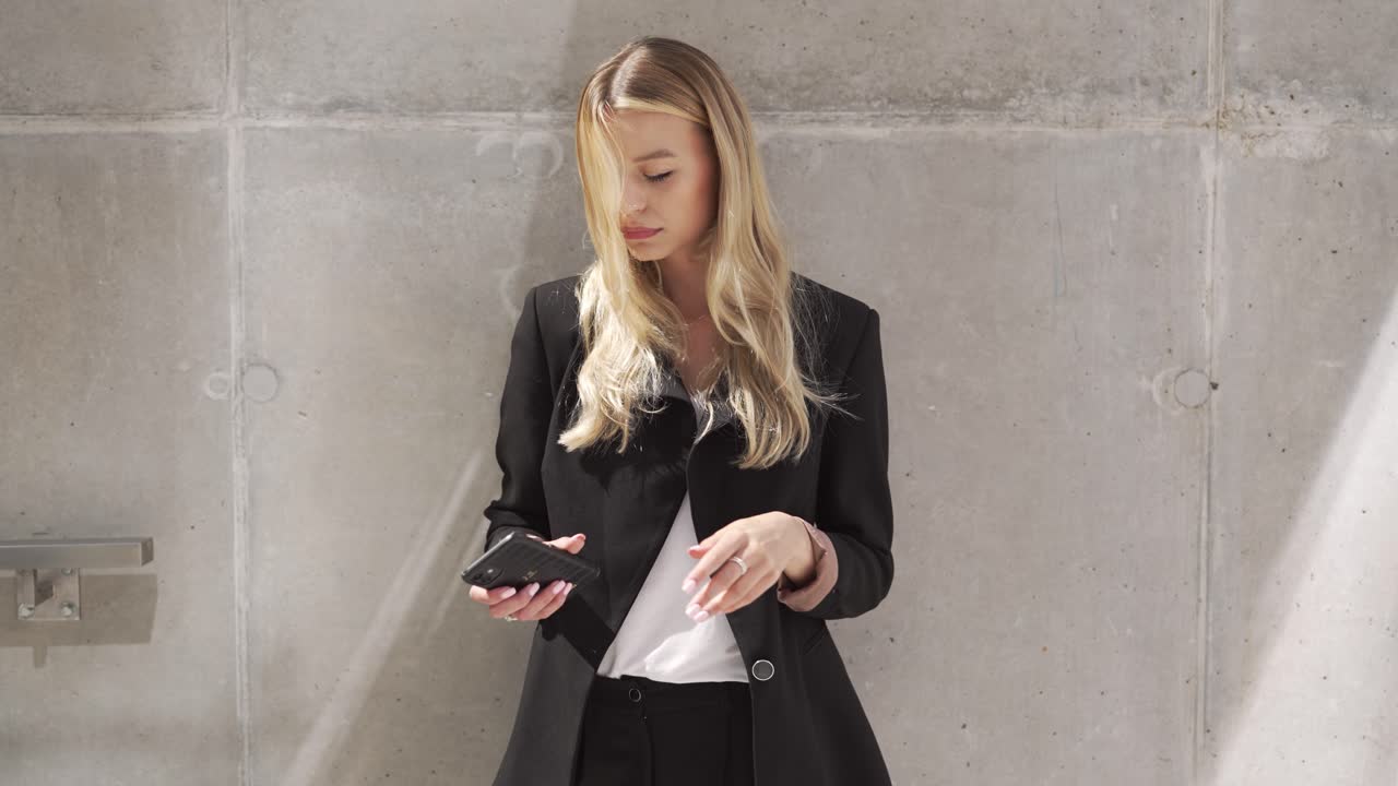Businesswoman using smartphone outdoors