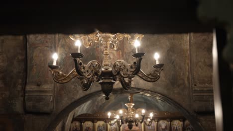 Close-up-of-gold-chandelier-inside-of-a-beautiful-old-Greek-church