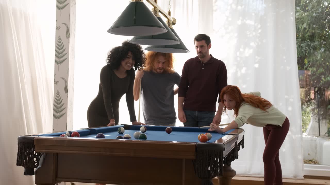 Friends watching woman playing pool in game room