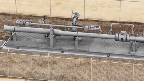 aerial view of a natural gas steel pipeline - tracking, telephoto drone shot