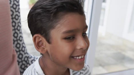 Portrait-of-happy-biracial-boy-at-home,-slow-motion