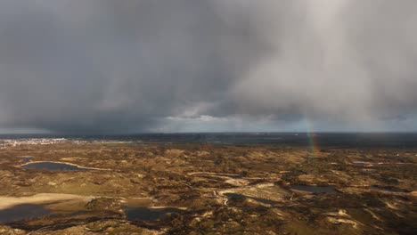 rainbow over dutch dunes