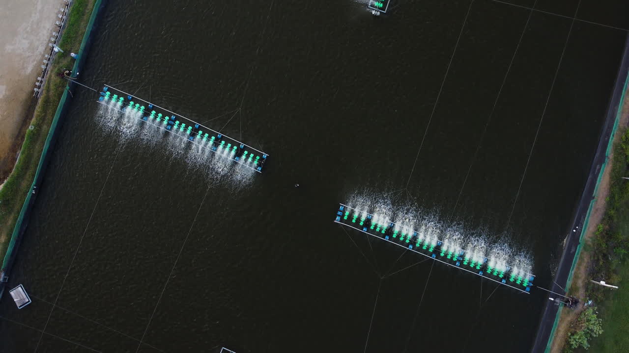 Aerial top down shot aerators at fishing farm during sunny day in Vietnam,Asia