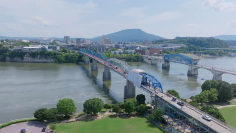 an aerial view of downtown chattanooga, tn, showcases the walnut street bridge under renovation, with the tennessee river and lookout mountain visible in the background